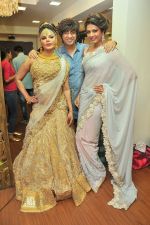 Rakhi Sawant with Rohit Verma and Priyanka Shah at the launch of Rohit Verma